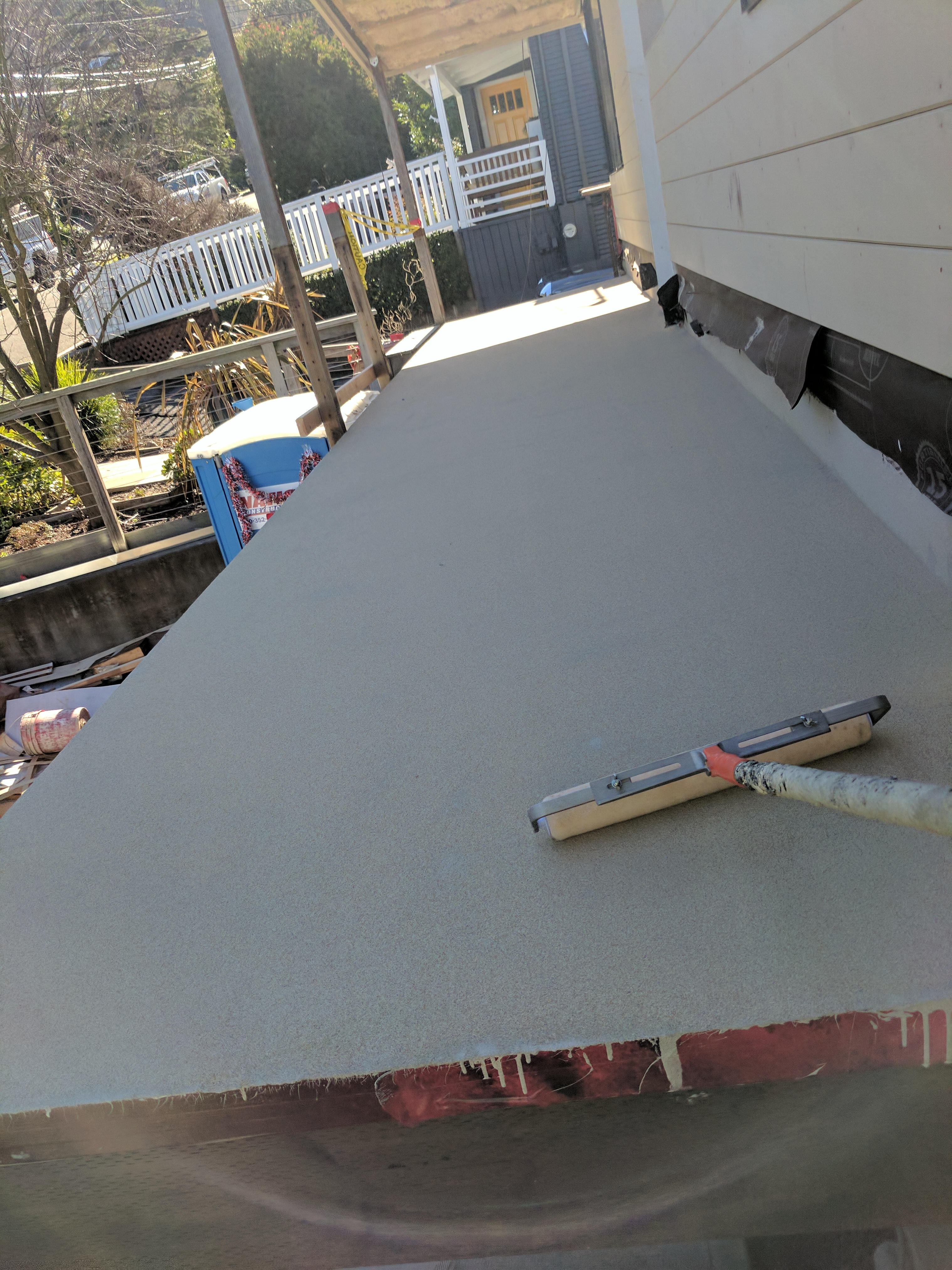 Backrolling the sand coat on a urethane deck in San Rafael, Marin County, CA
