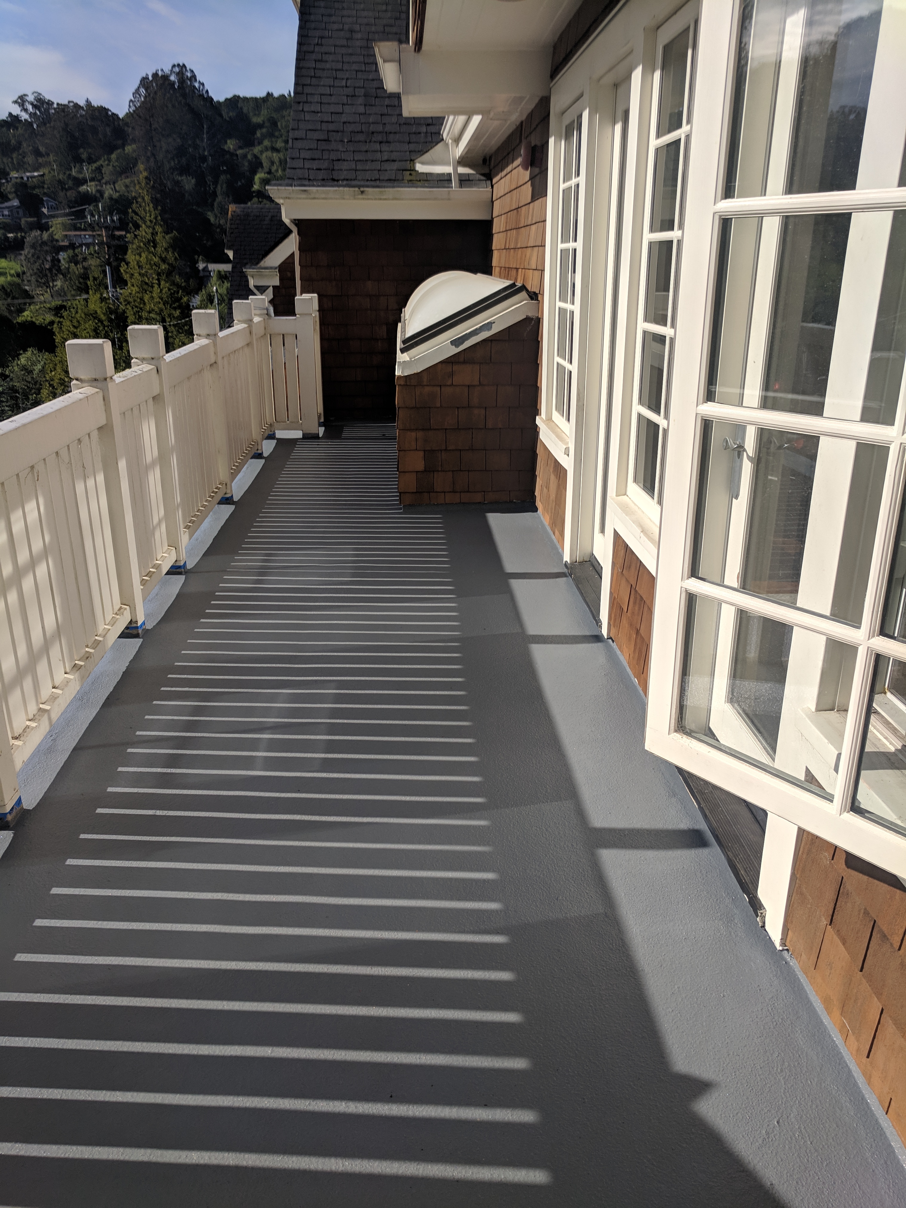 A completed deck over living space in San Rafael, Marin County, CA. Urethane coating in pacific gray.