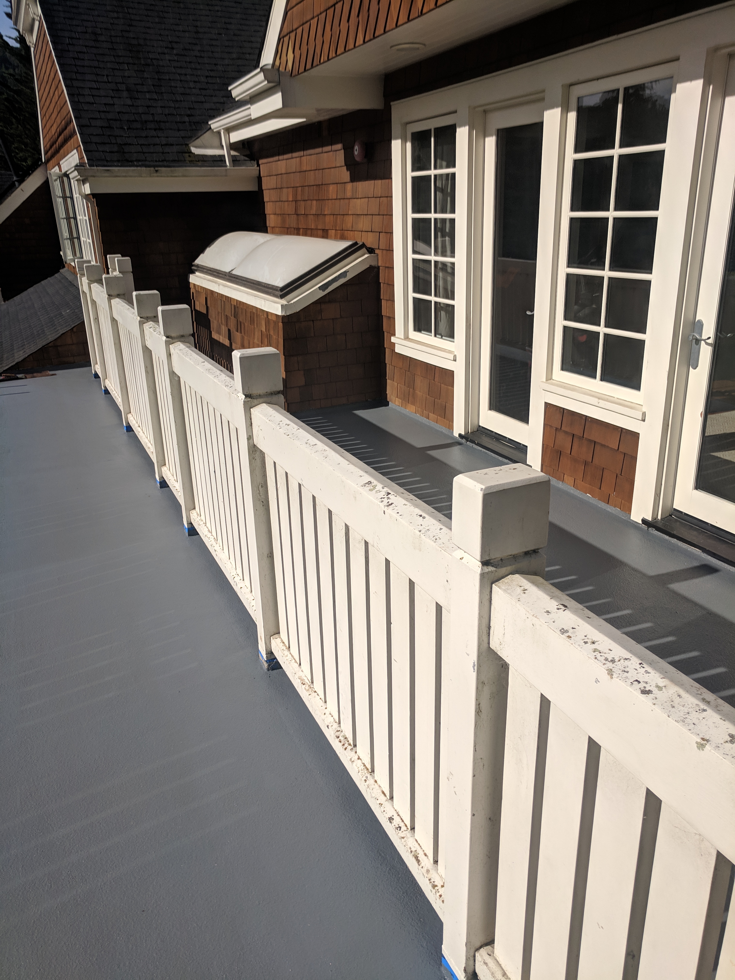 A completed deck over living space in San Rafael, Marin County, CA. Urethane coating in pacific gray.